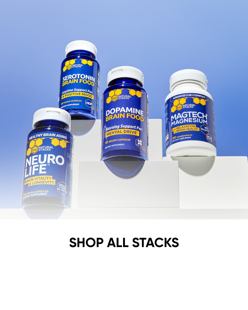 Four supplement bottles on a white surface with a blue sky background