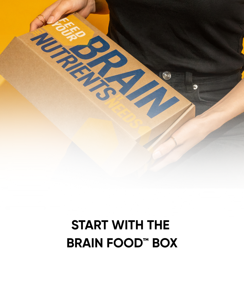 Person holding a cardboard box labeled 'Feed Your Brain' with text 'Start with the Brain Food Box'.