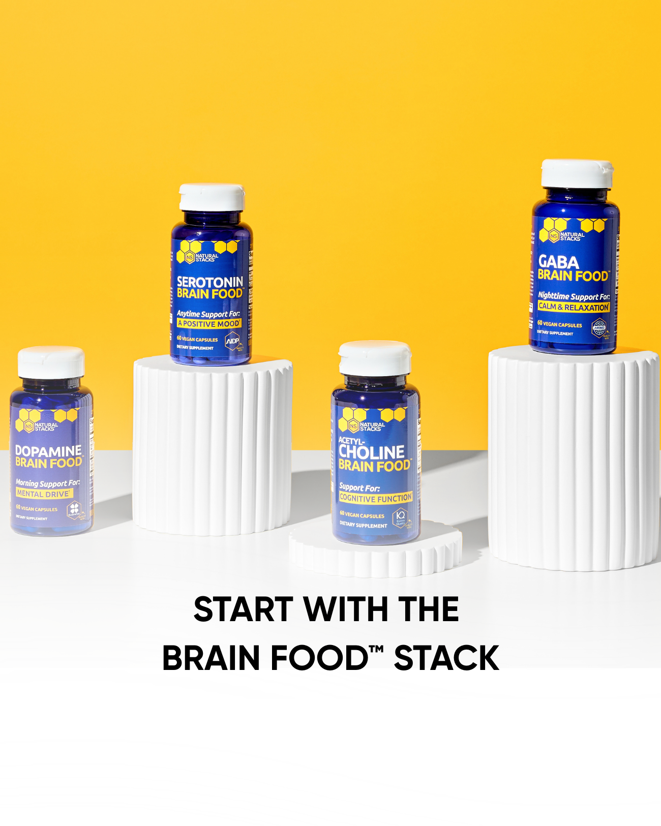 Supplement bottles labeled 'Serotonin Brain Food', 'Dopamine Brain Food', 'Choline Brain Food', and 'GABA Brain Food' on a white surface with a yellow background.