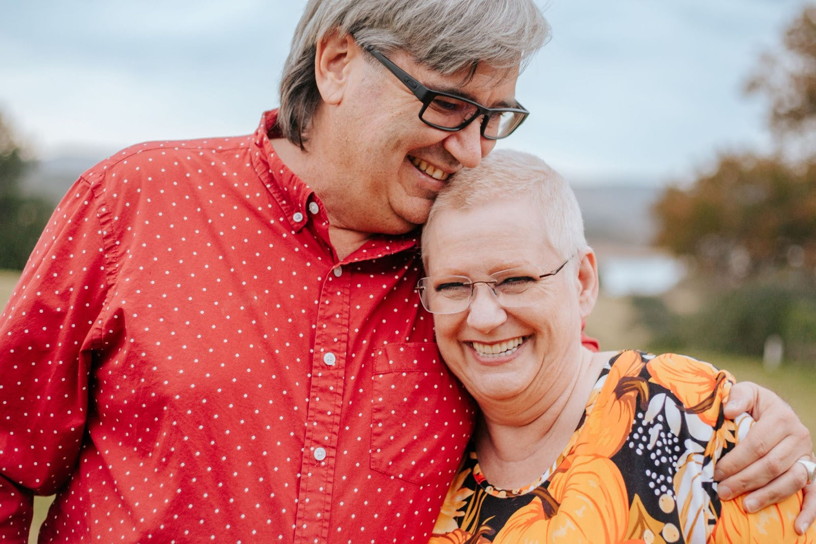 elderly couple smiling while man hold woman