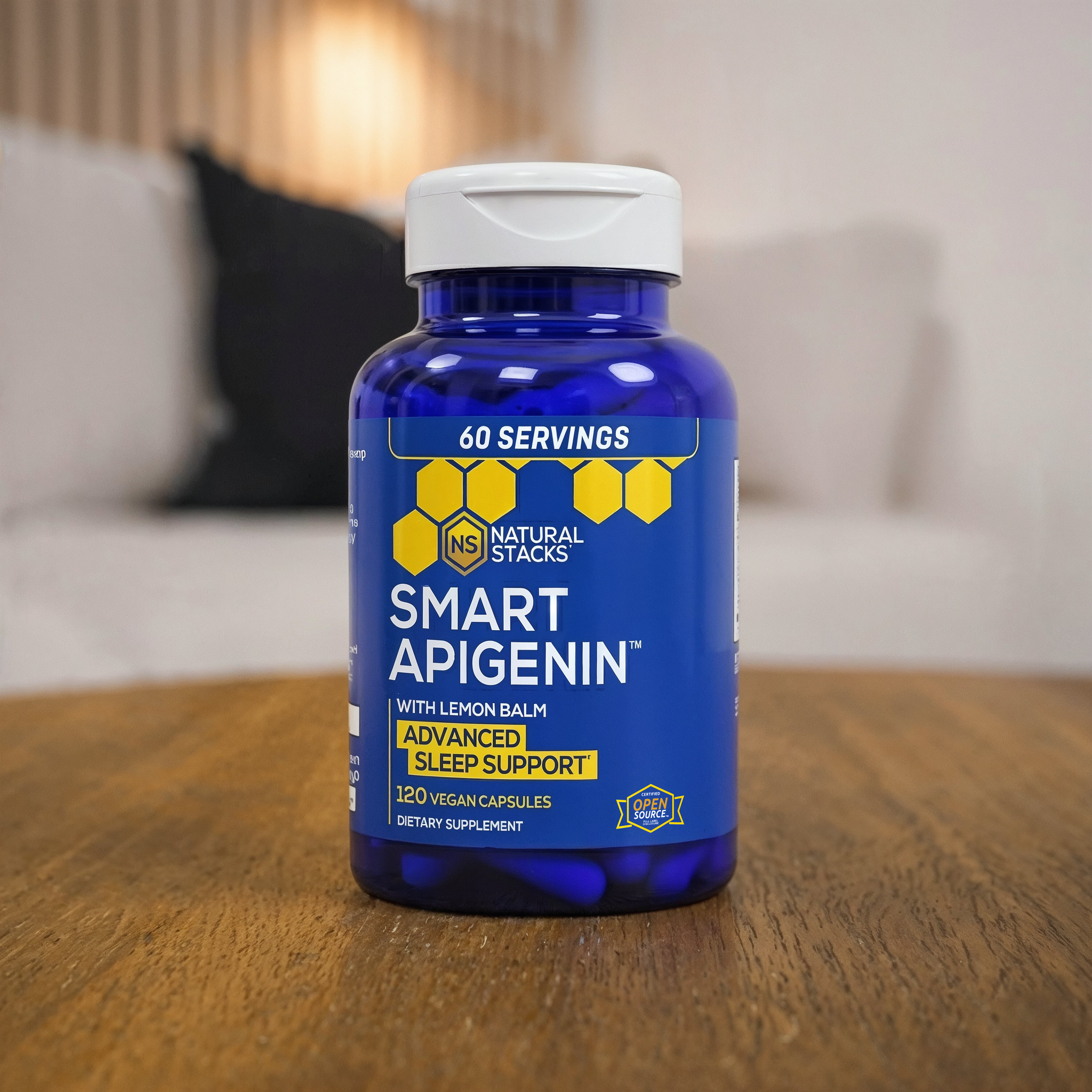 A bottle of Smart Apigenin on a wooden surface with a blurred living room background