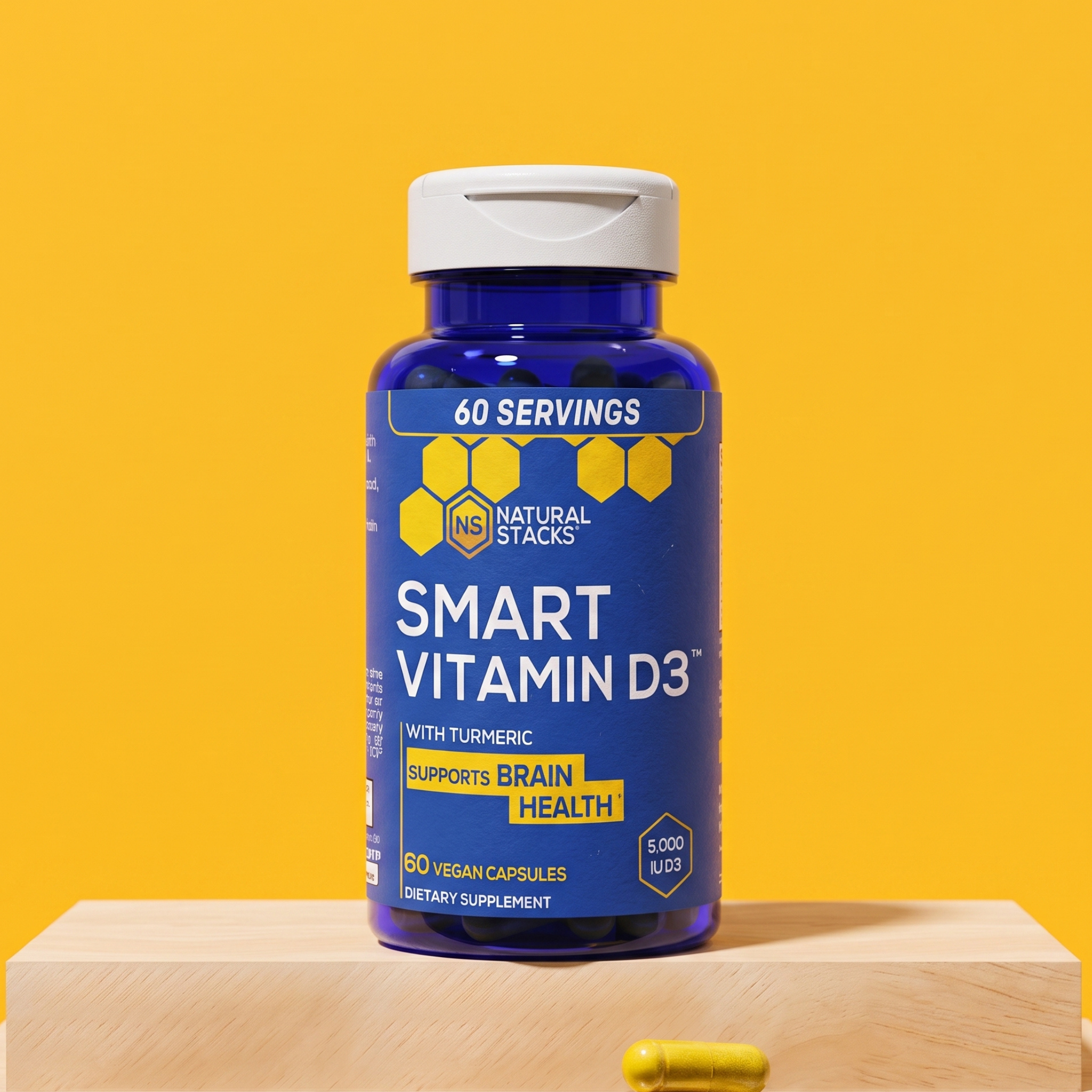 Bottle of Smart Vitamin D3 on a wooden block against a bright yellow background, with a single capsule placed in front of the block.