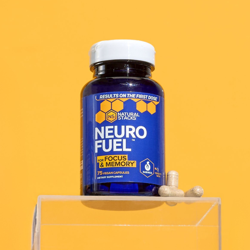 Bottle of Neuro Fuel supplement with capsules on a yellow background