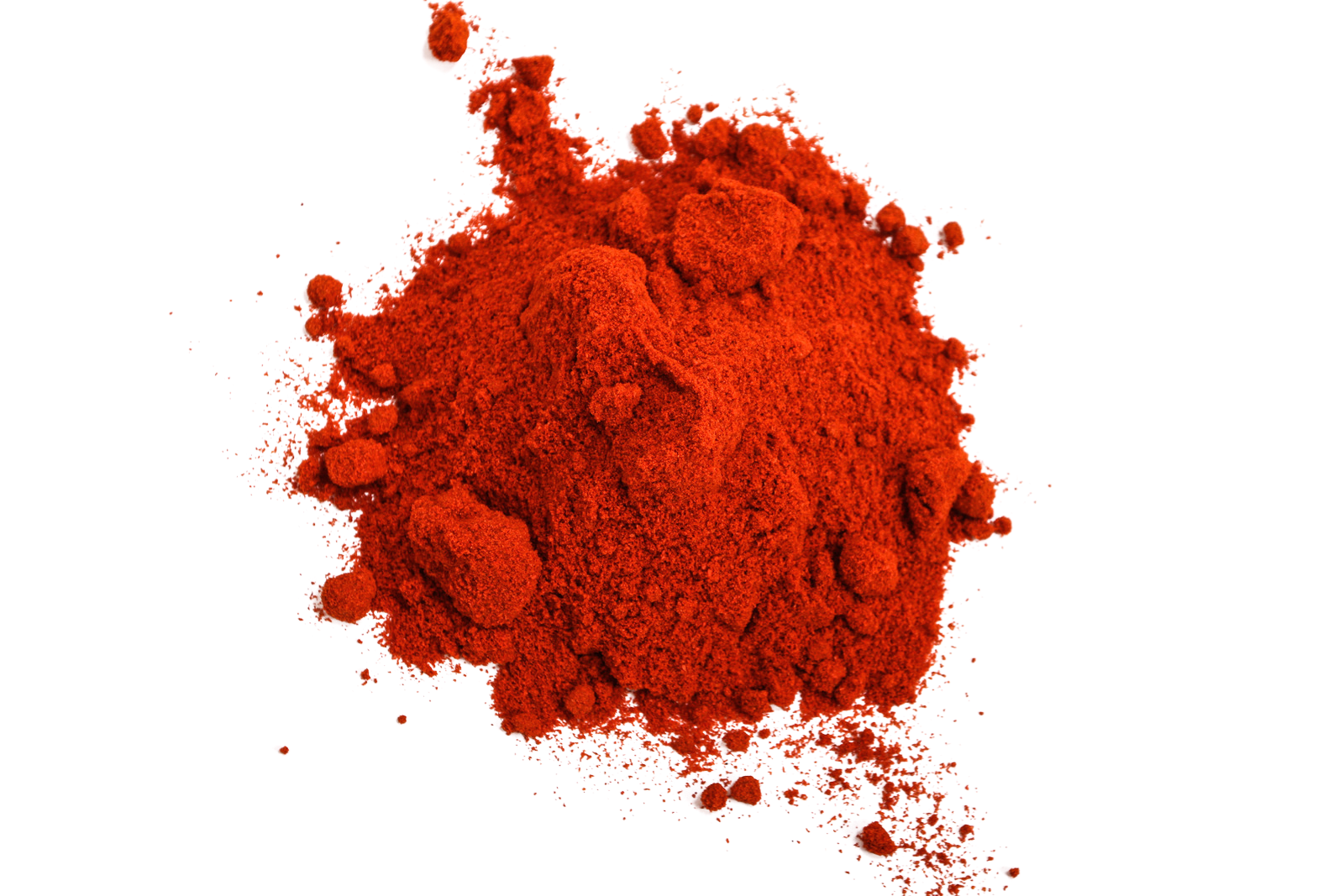 A pile of vibrant red paprika powder, scattered on a black background.